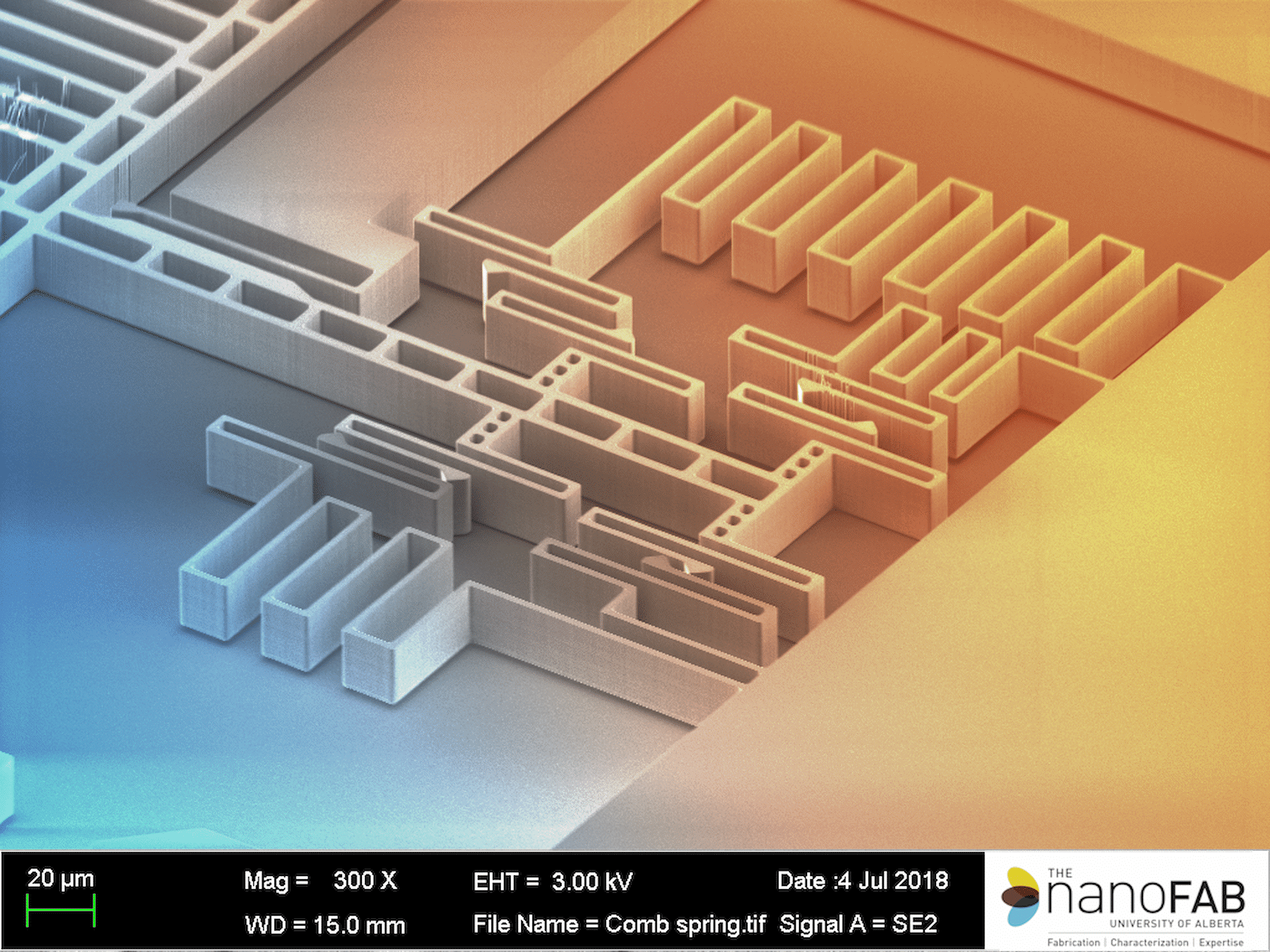 A close-up view of a microchip structure with intricate, layered patterns in blue and orange hues. Text at the bottom provides technical details about the image and scanning electron microscope settings.