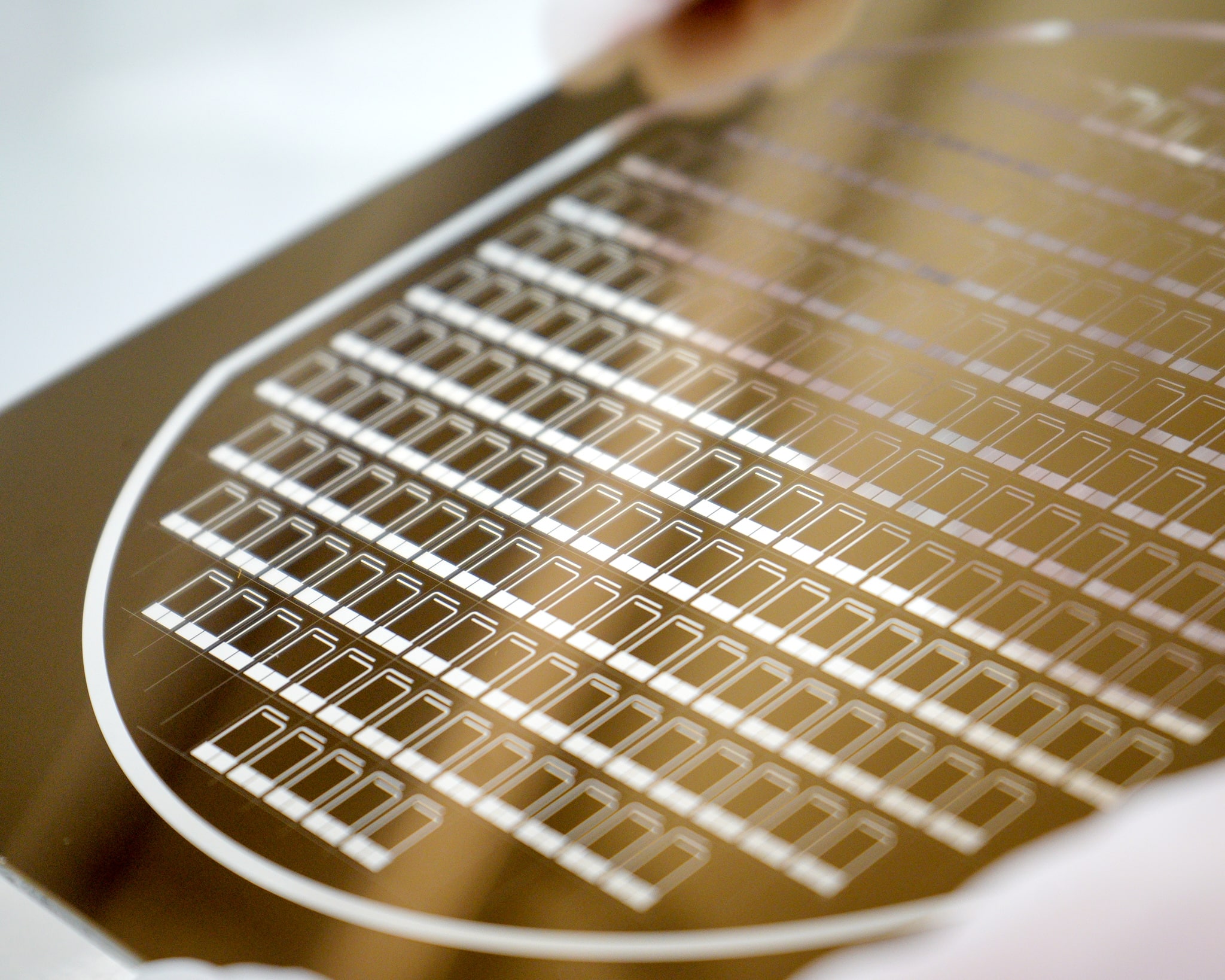 Close-up of a high-resolution photomask used in advanced lithography at the University of Alberta nanoFAB, showcasing intricate patterns for semiconductor manufacturing and microfabrication.