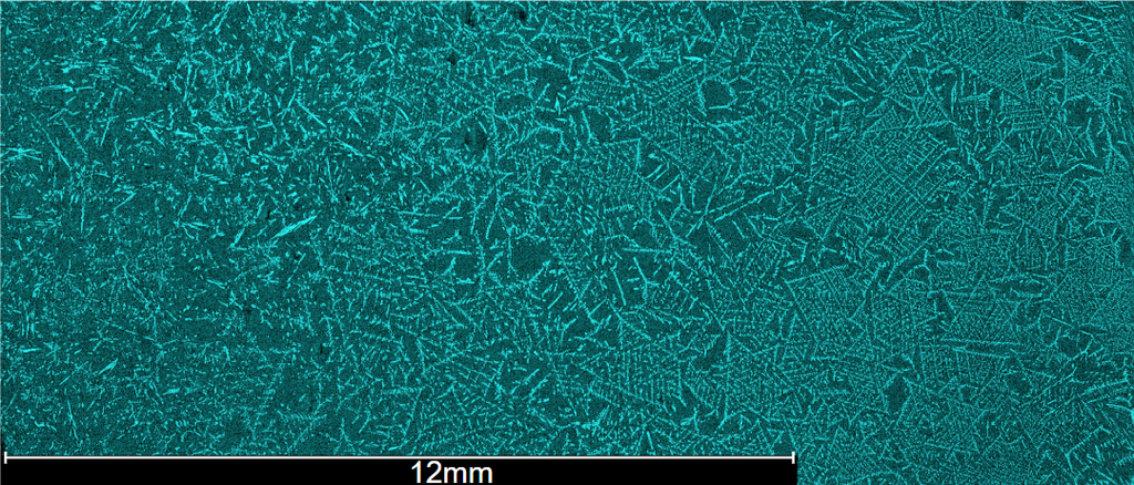 Microscopic FESEM view of a teal-colored crystalline structure with a 12mm scale bar at the bottom.
